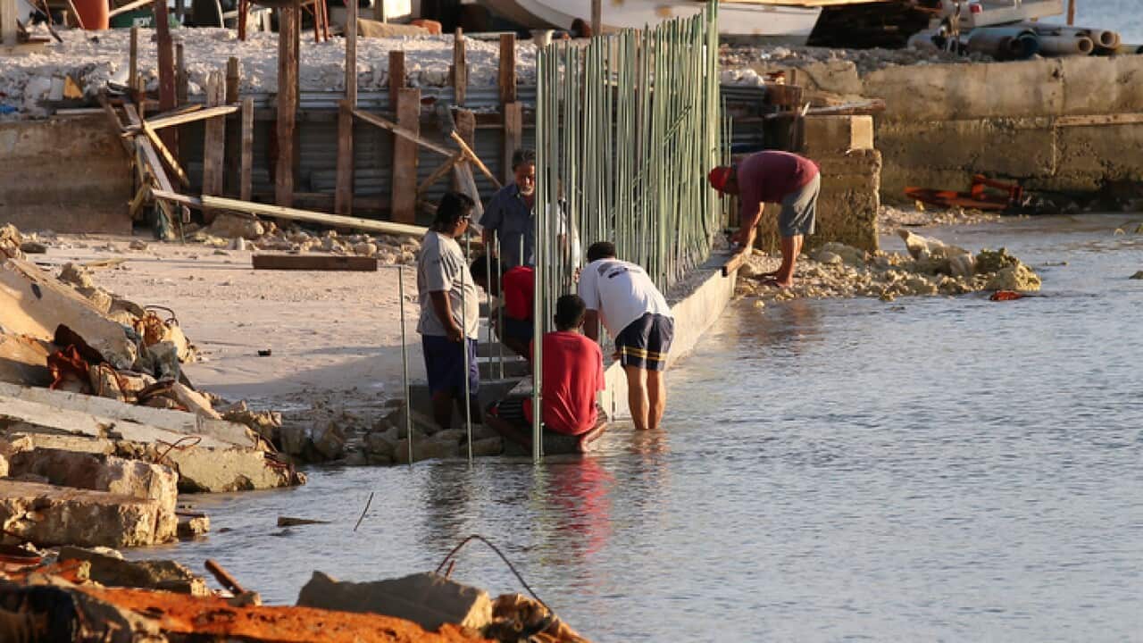Workers build a sea wall in the Marshall Islands in a bid to prevent floods from rising sea levels