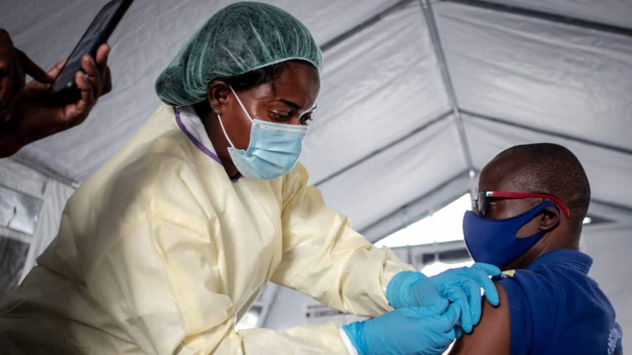 A health worker administers a COVID-19 vaccine in the Democratic Republic of Congo.