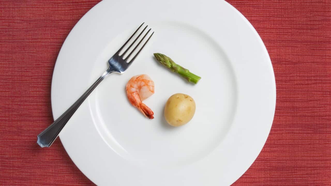 tiny meal consisting of one shrimp, a tiny potato, and a single short asparagus stalk