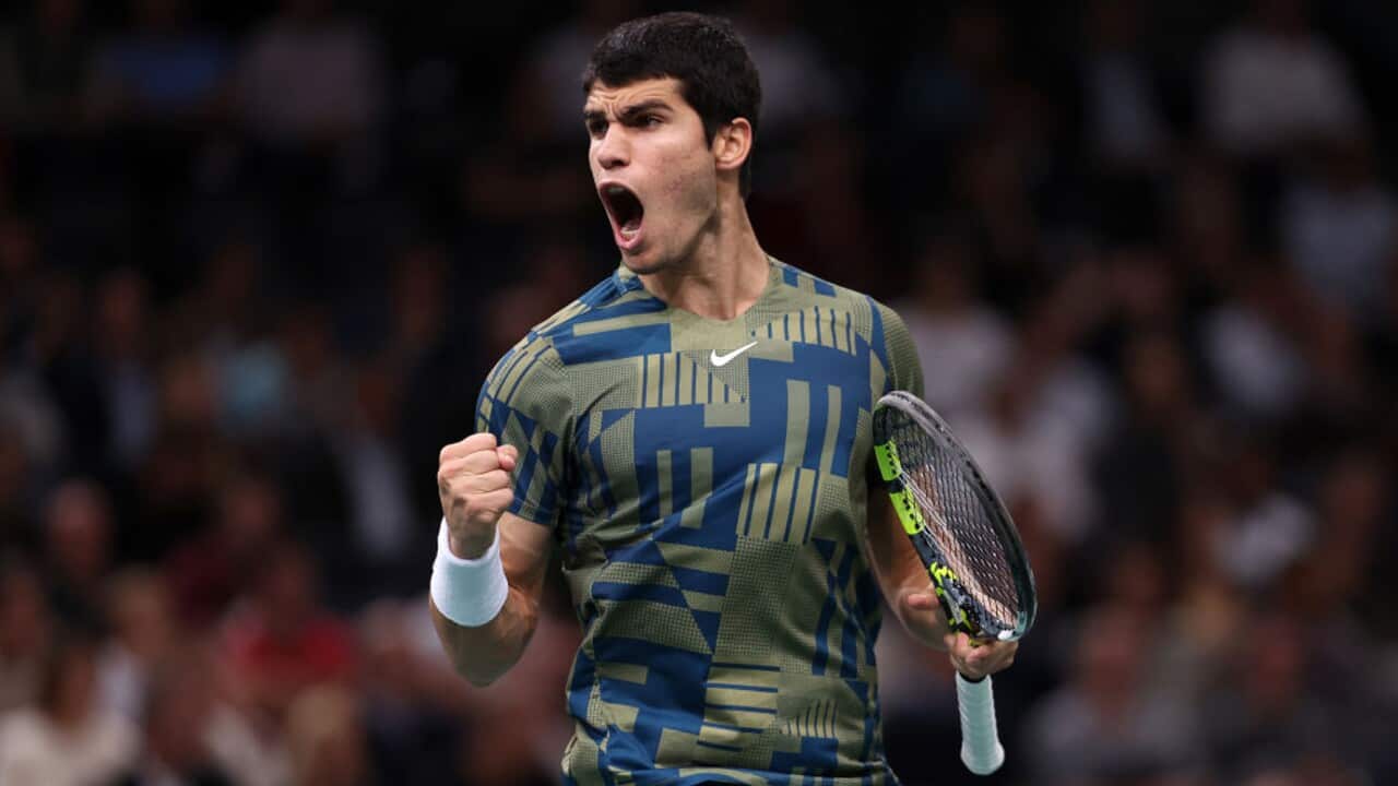 Carlos Alcaraz celebrates a point in a tennis match