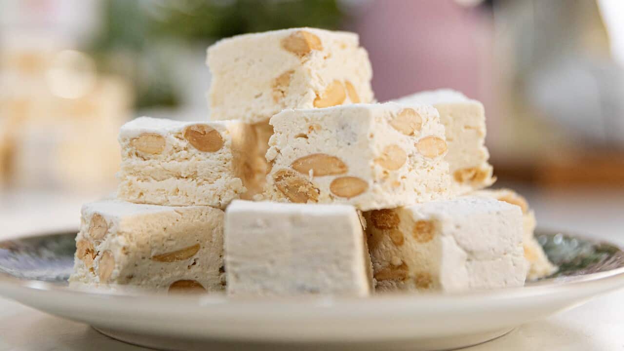 A stack of nougat pieces sit on a round plate.