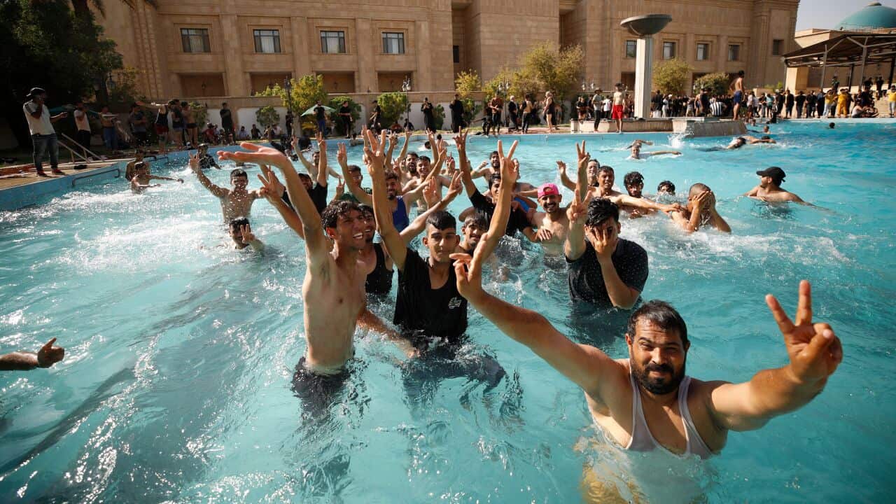 Supporters of Iraqi Shiite cleric Moqtada Sadr swim in the pool of the Government Headquarters in the capital Baghdad
