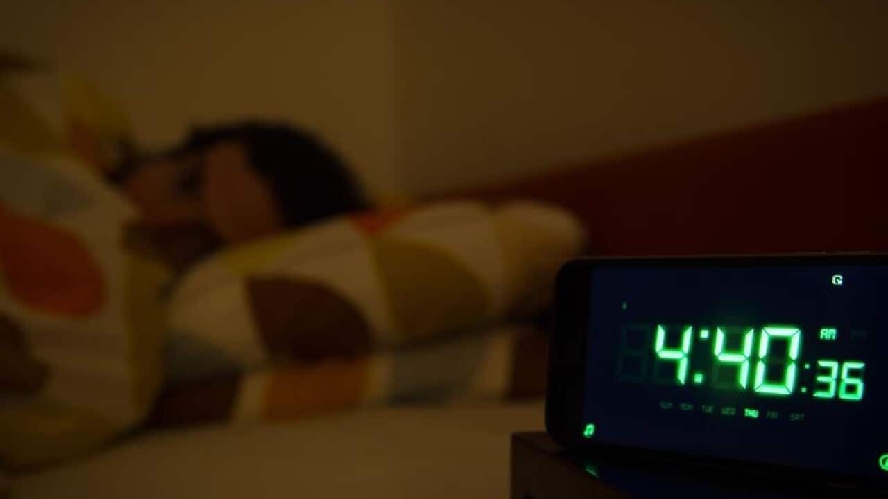 A man sleeping in a bed.