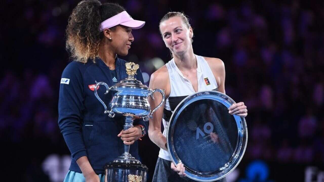 Naomi Osaka holds the Australian Open trophy alongside Petra Kvitova