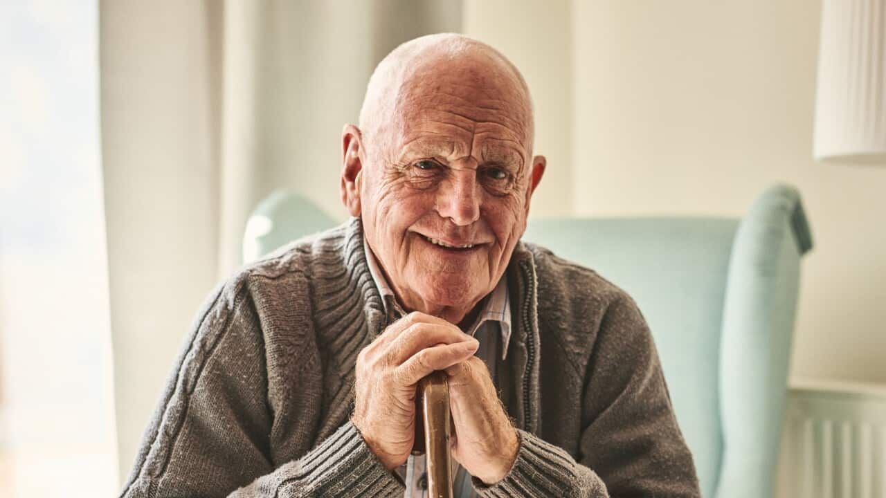 Happy senior man sitting at home