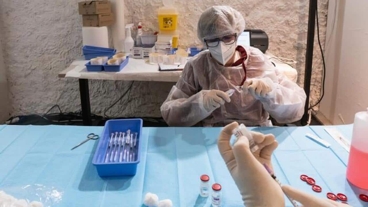 داکتری در حال آماده کردن واکسین استرازنکا