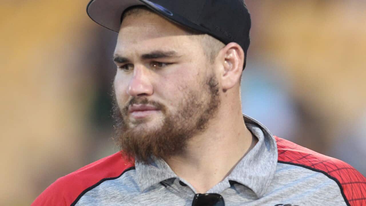 NRL player Russell Packer watching a match from the sidelines