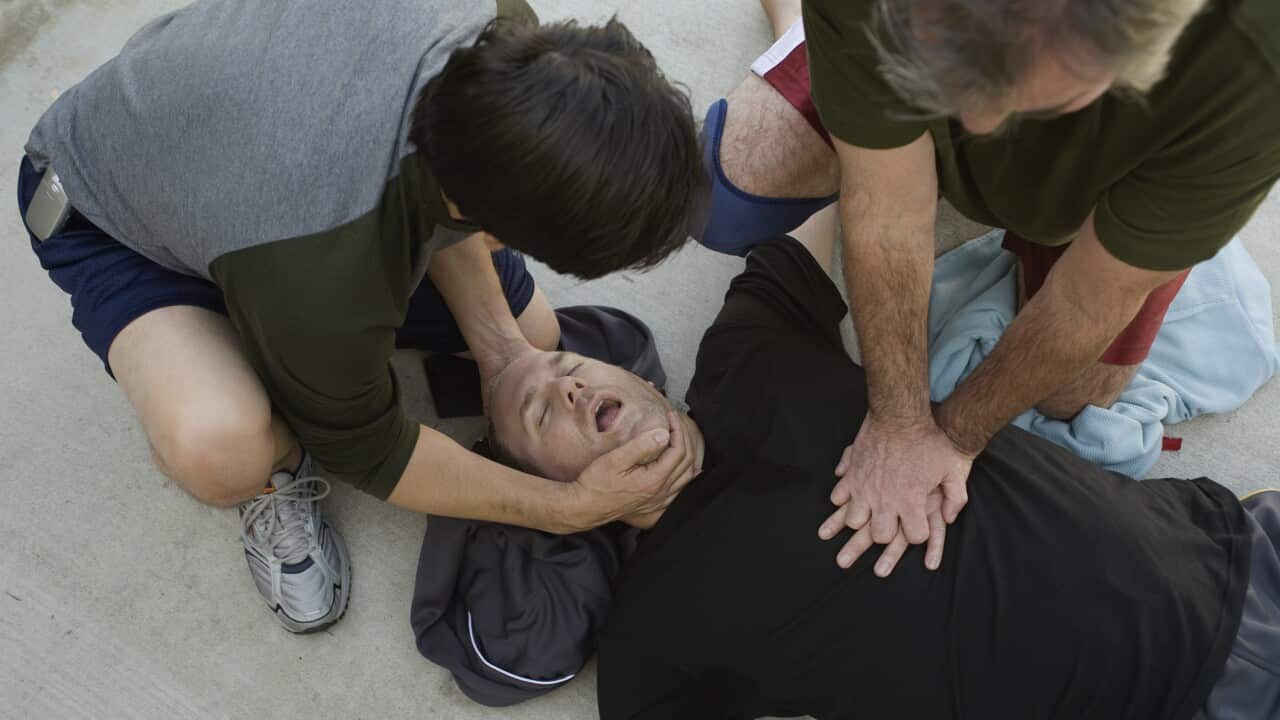 Men doing CPR on another man