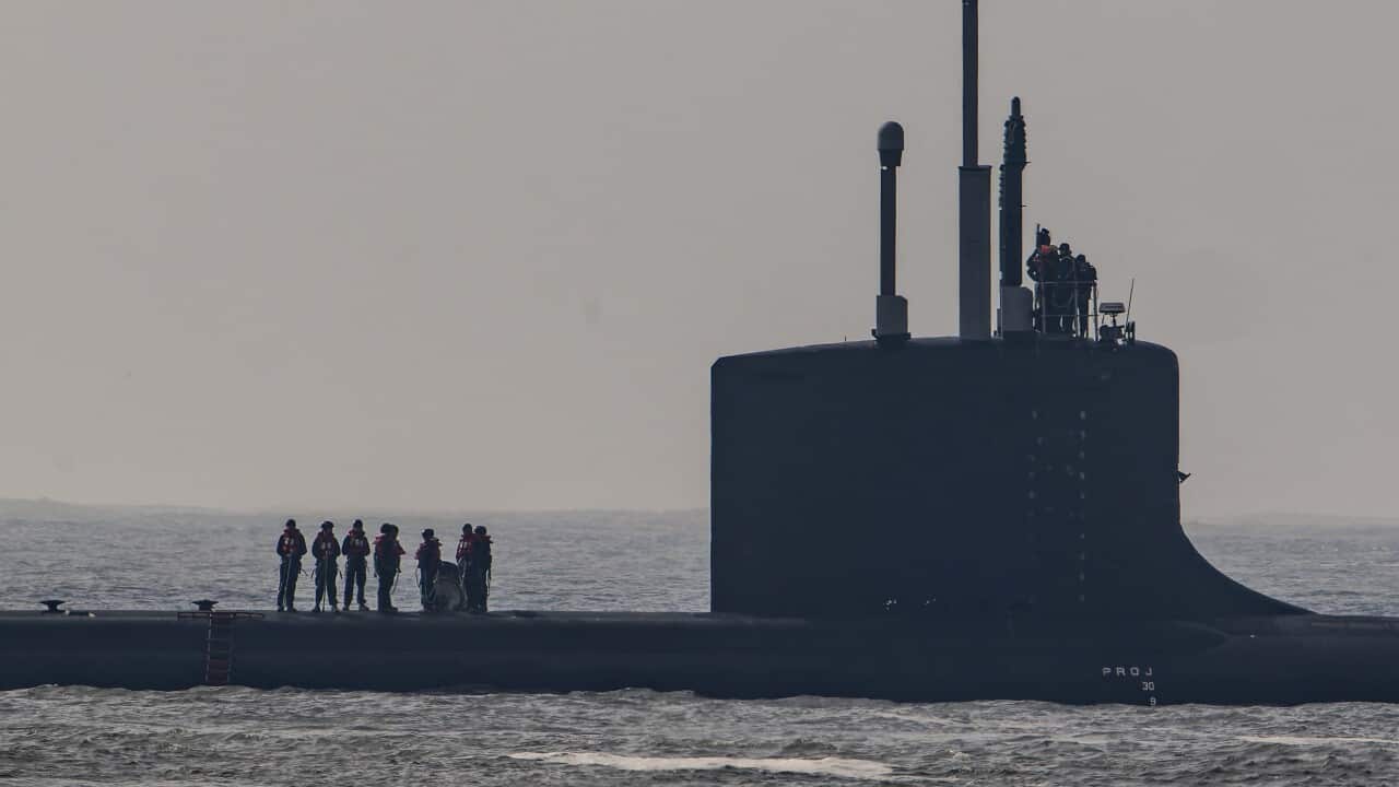 Crew members on the deck of a submarine.