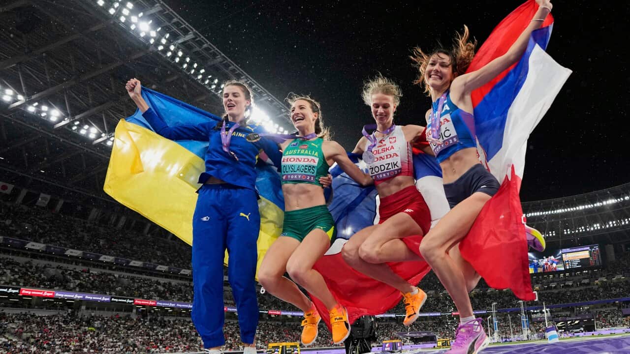 Gold medalist Australia's Nicola Olyslagers, second left, celebrates with silver medalist Poland's Maria Żodzik, second right, and joint bronze medal winners Ukraine's Yaroslava Mahuchikh, left, and Serbia's Angelina Topic, right, following the women's high jump final at the World Athletics Championships in Tokyo
