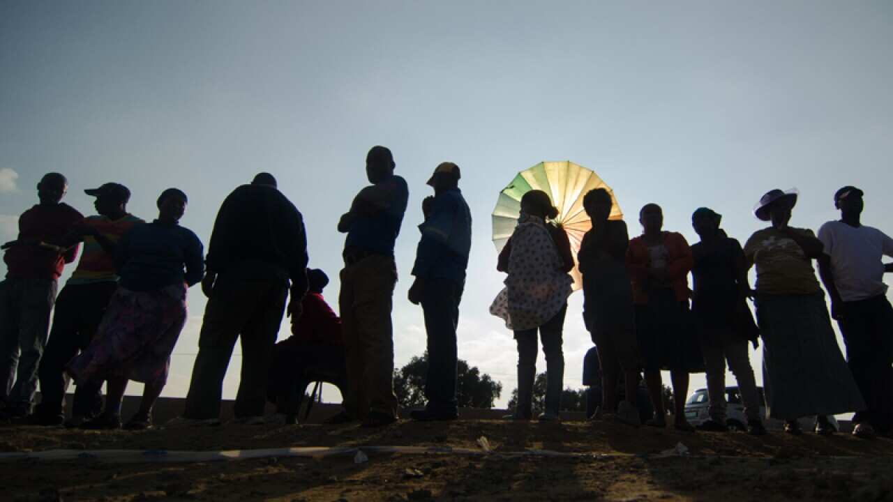 Voters queue for a voting station