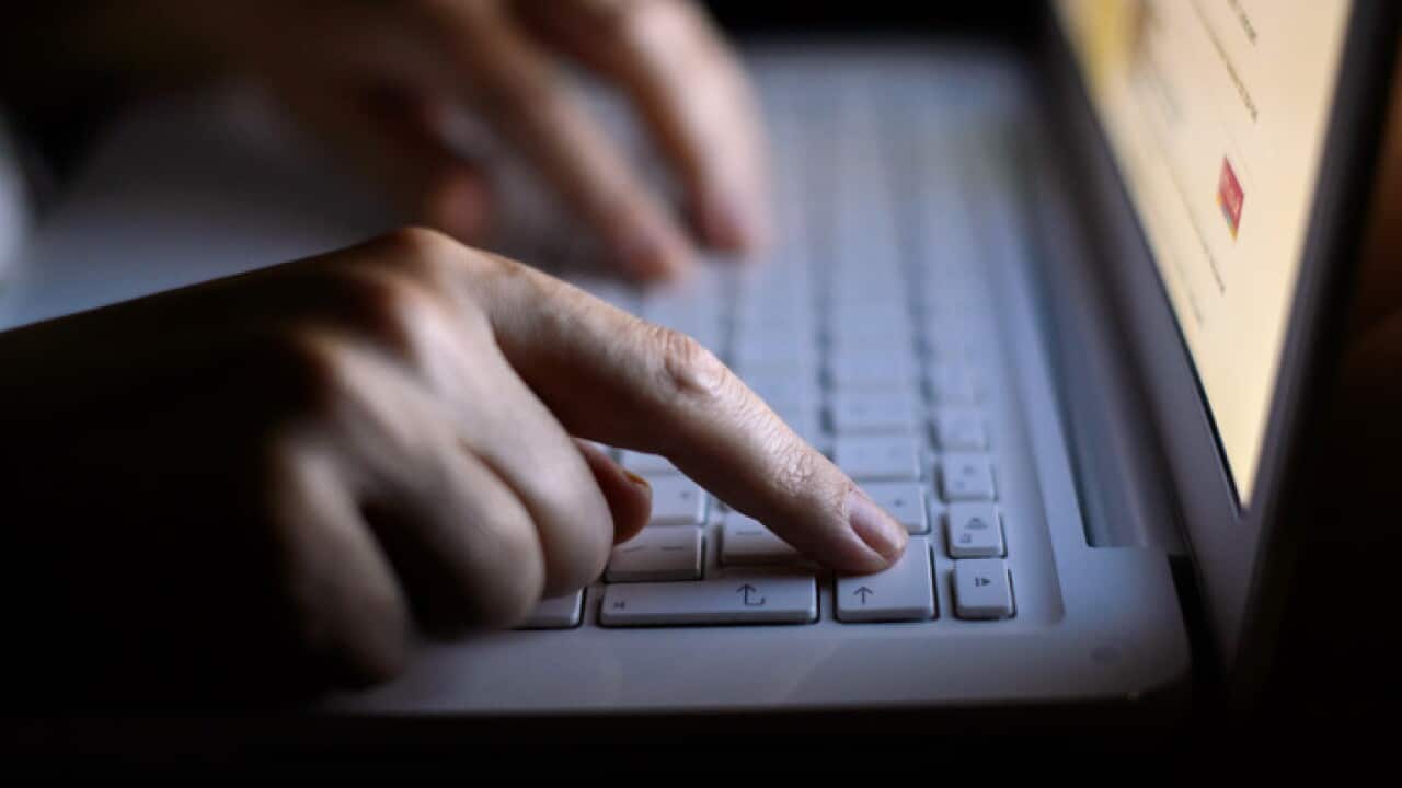 A woman uses a laptop