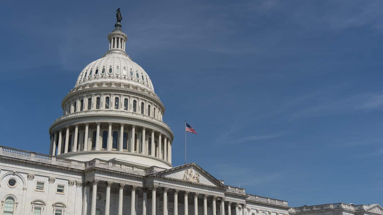 The United States Capitol building in Washington DC, under a clear blue sky.