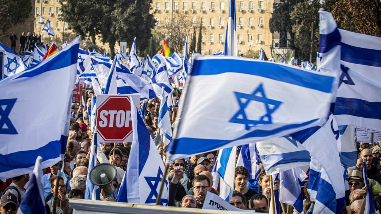 Protesters wave Israeli flags during a demonstration against judicial reform on 20 February 2023.