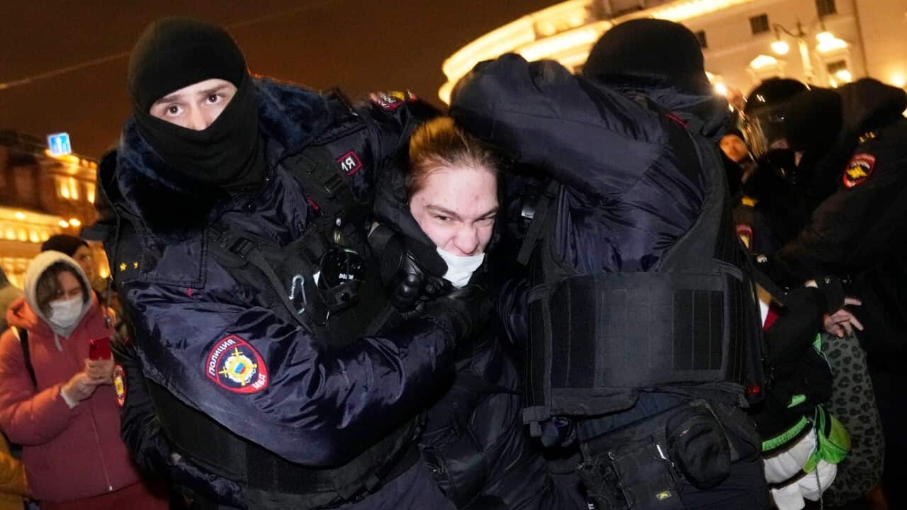 Police officers detain a demonstrator in St. Petersburg, Russia, Thursday, Feb. 24, 2022. Hundreds of people gathered in the centers of Moscow and St.Petersburg on Thursday, protesting against Russia's attack on Ukraine.