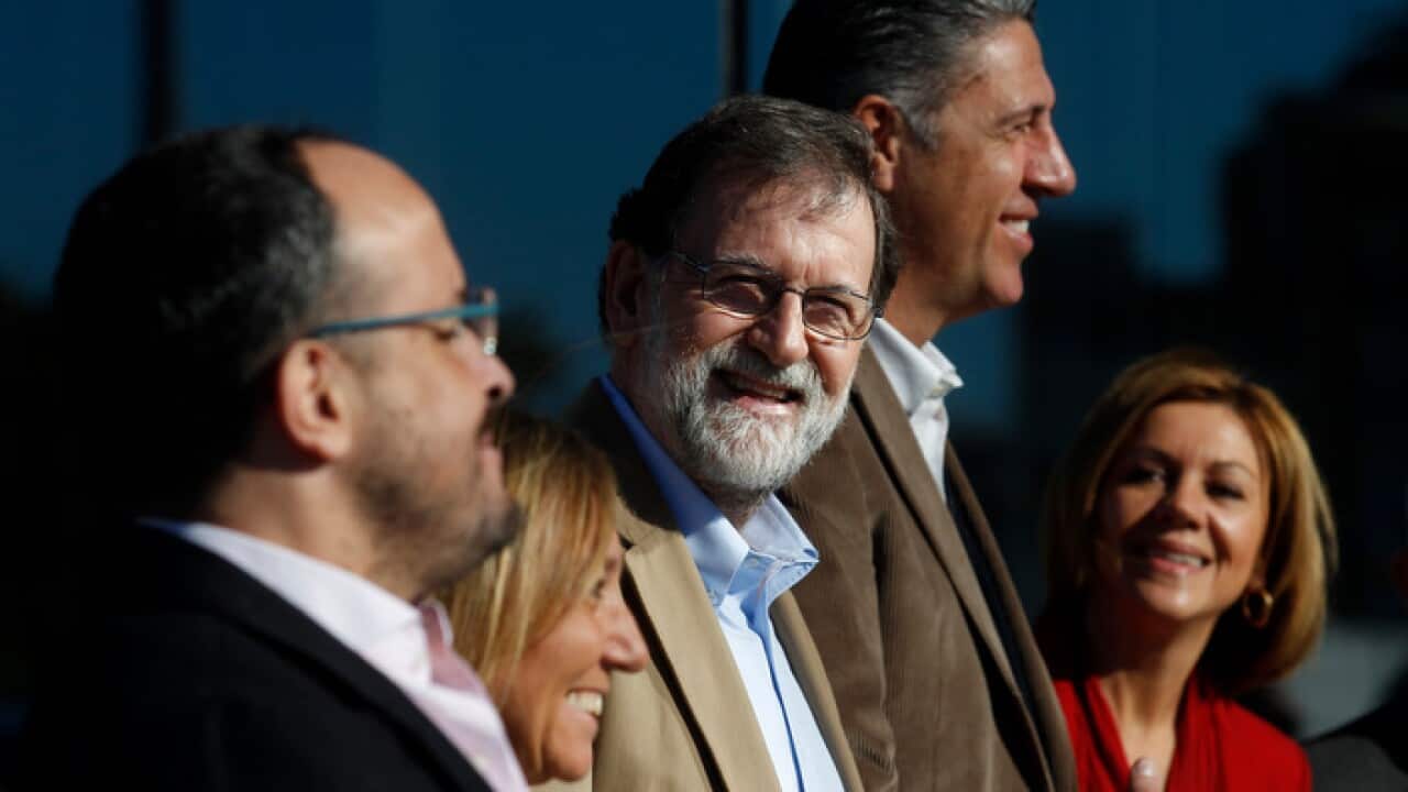 Spain's Prime Minister Mariano Rajoy, center, attends a Catalan regional People's Party meeting in Barcelona, Spain.