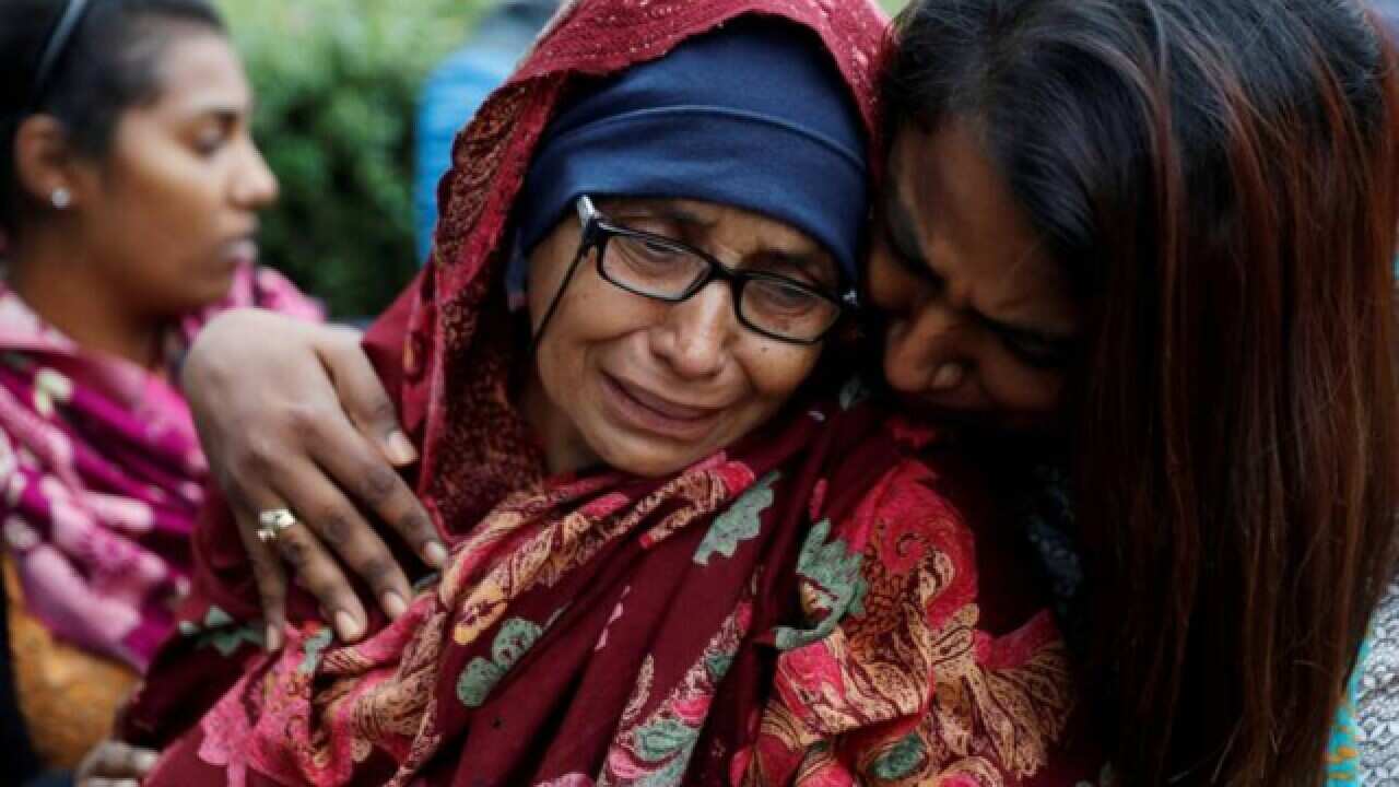 A day after the attack a woman waiting for news about missing loved ones reacts at a community centre near Masjid Al Noor.