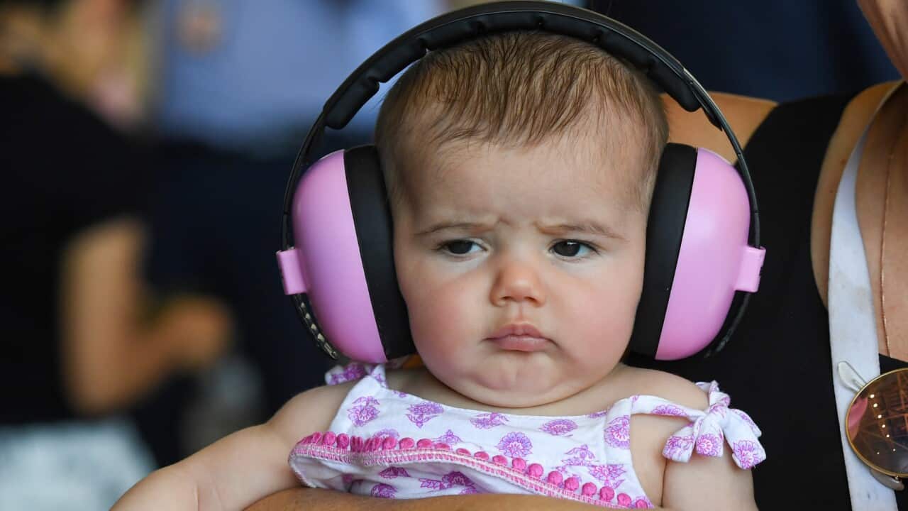 A baby wearing ear protection