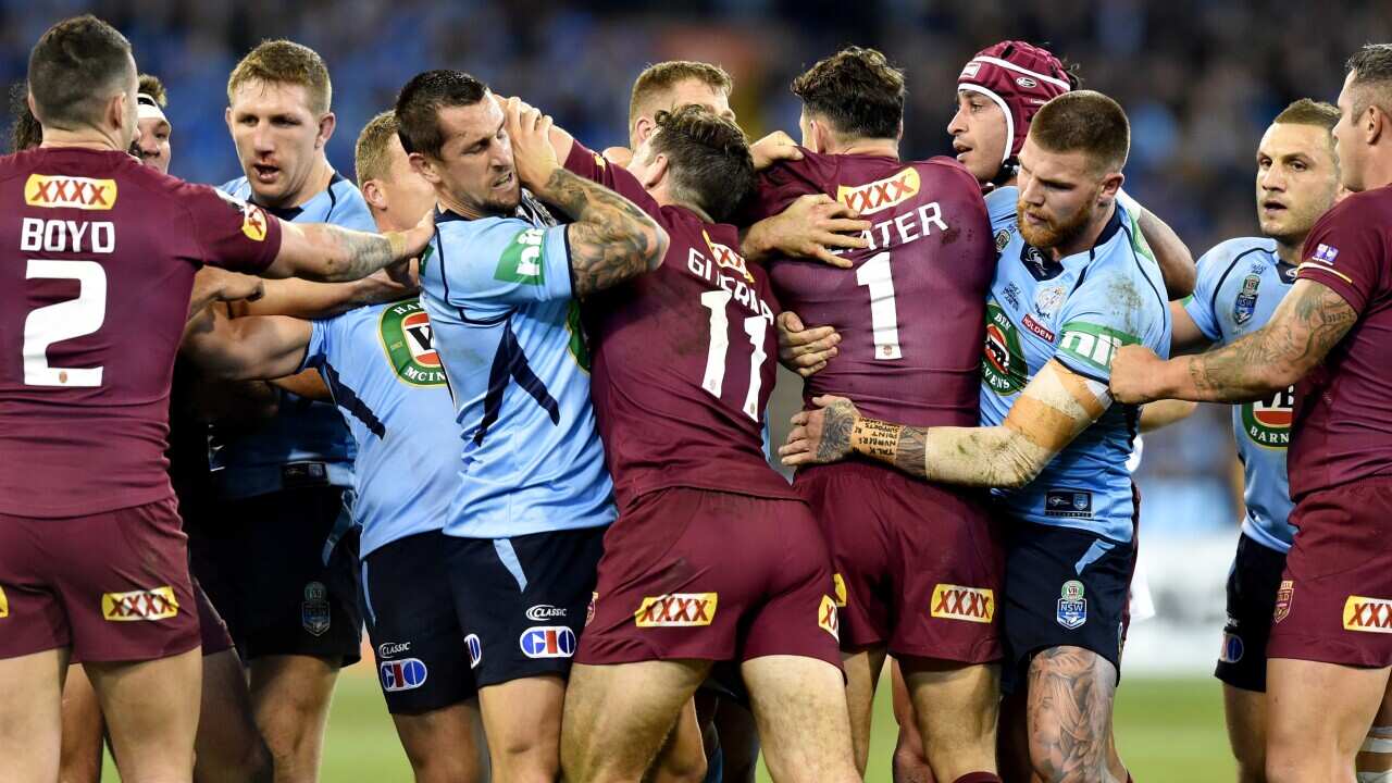 A fight breaks out during State of Origin Game II between the NSW Blues and Queensland Maroons, at the MCG, Melbourne, Wednesday, June 17, 2015. (AAP Image/Joe Castro) NO ARCHIVING, EDITORIAL USE ONLY