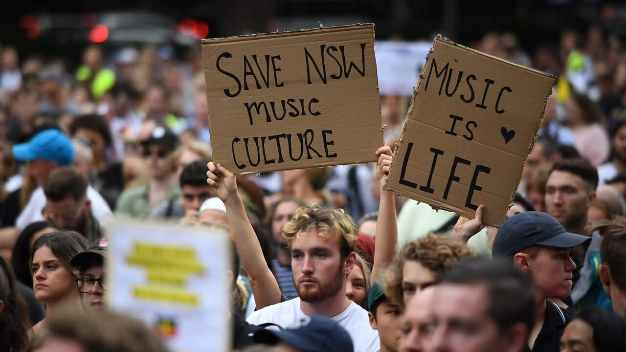 Protestors hold placards during the Don't Kill Live Music Rally in Sydney.