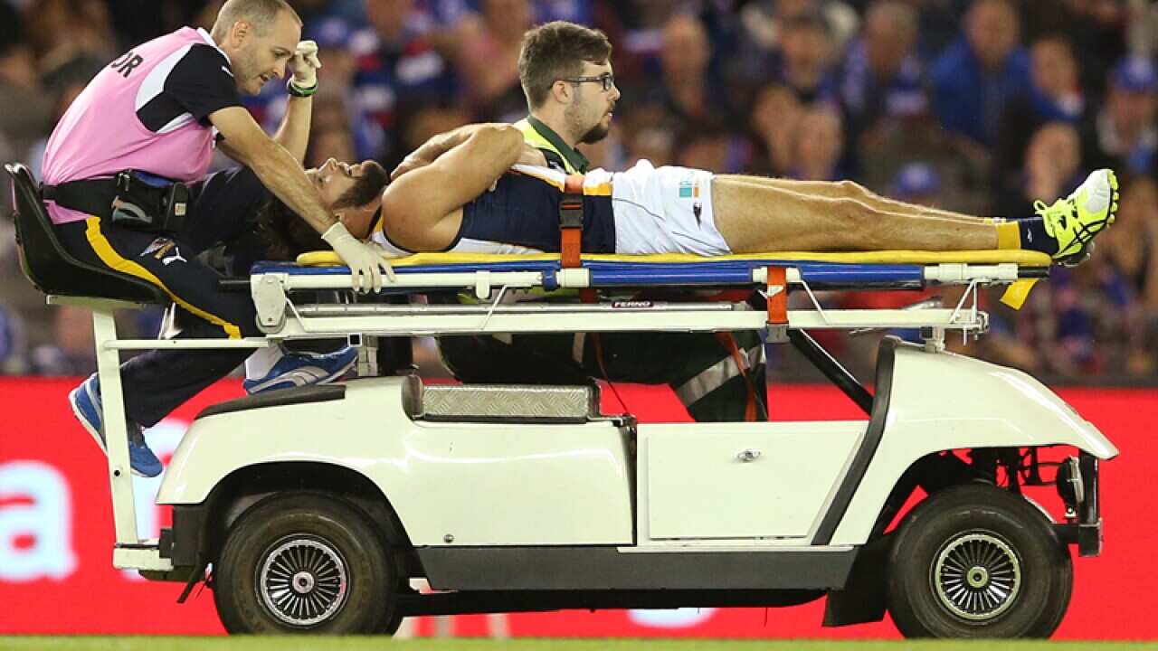 Mitch Brown is taken off on a stretcher