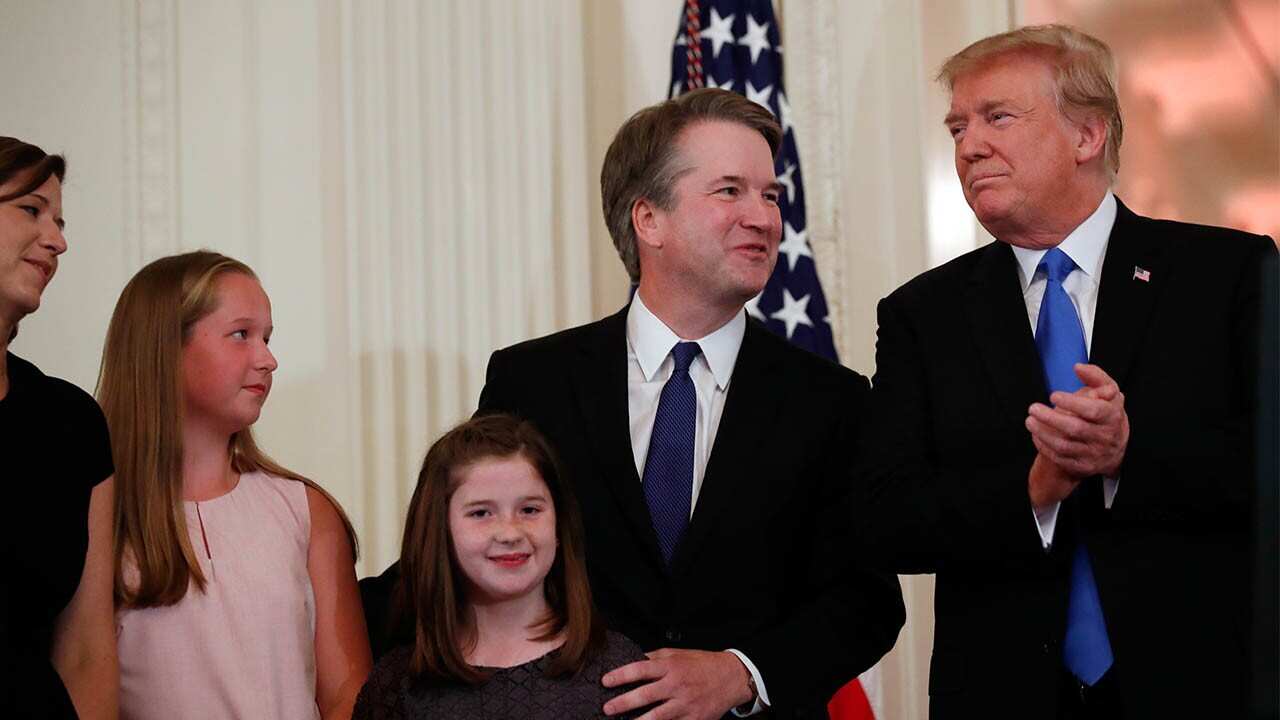 President Donald Trump stands with Judge Brett Kavanaugh his Supreme Court nominee, and his family.