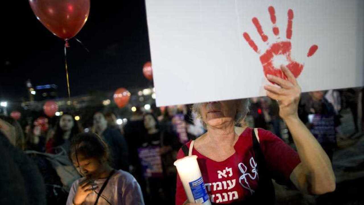 A woman hold sign during a protest against violence against women in Tel Aviv, Israel.
