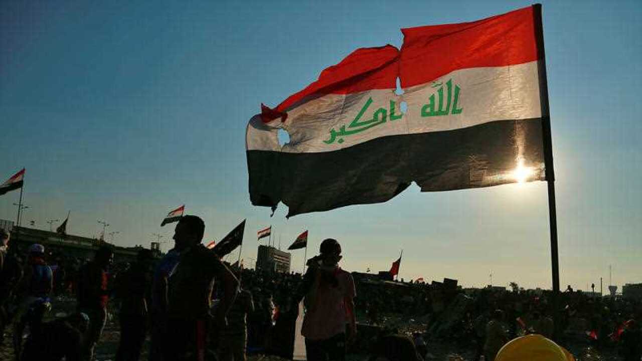 Anti-government protesters gather near the Tigris River during ongoing protests in Baghdad.