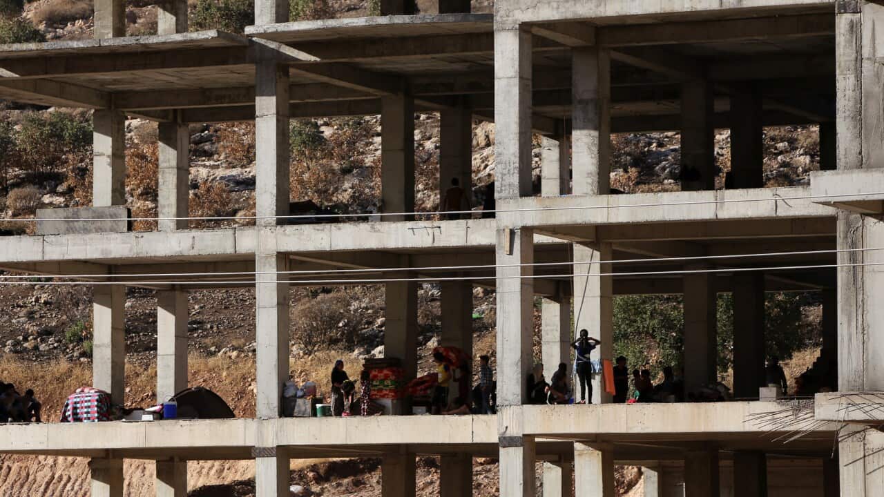 Iraqi Yazidis, who fled their homes when IS militants attacked the town of Sinjar, inside a building under construction where they found refuge in August. (AFP/Getty)