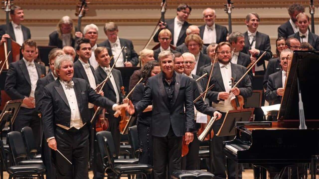 jean-Yves Thibaudet, center, performed Liszt's “Piano Concerto No. 2 in A Major“ with the Czech Philharmonic led by Jiri Belohlavek, left.(Photo by Hiroyuki Ito/Getty Images)