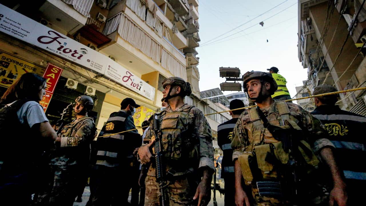 Lebanese army soldiers secure the site where an Israeli raid destroyed two apartments in a building in Beirut