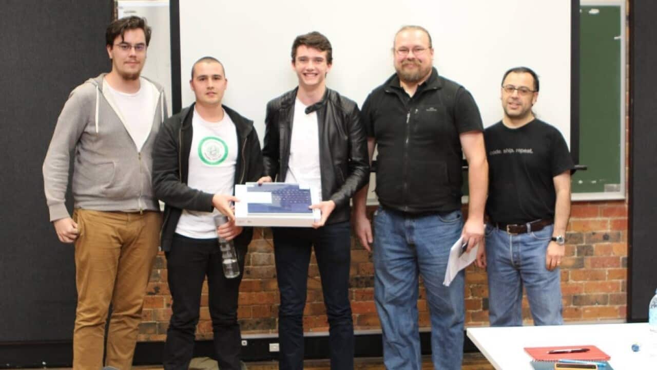 Austin Wilshire (middle) and Bernd Harzer (2nd from left) after winning the QUT hack-a-thon 