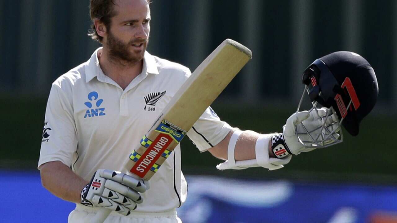 NZ's Kane Williamson waves to the crowd after scoring a century