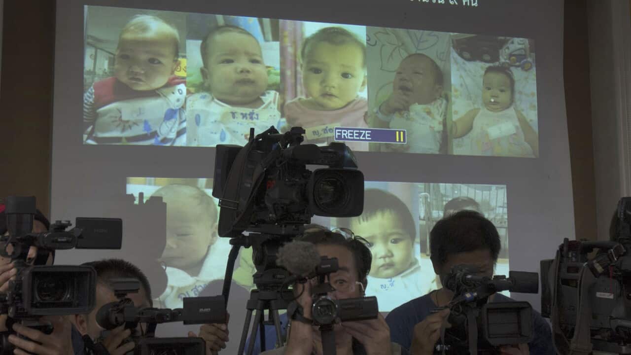 FILE Aug. 12, 2014 Thai police display projected pictures of surrogate babies born to a Japanese man who is at the center of a surrogacy scandal