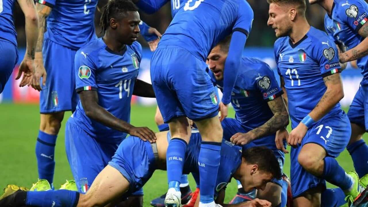 Italy's midfielder Nicolo Barella celebrates with teammates Moise Kean and Ciro Immobile after scoring during the Euro 2020 Group J qualifying football match. 