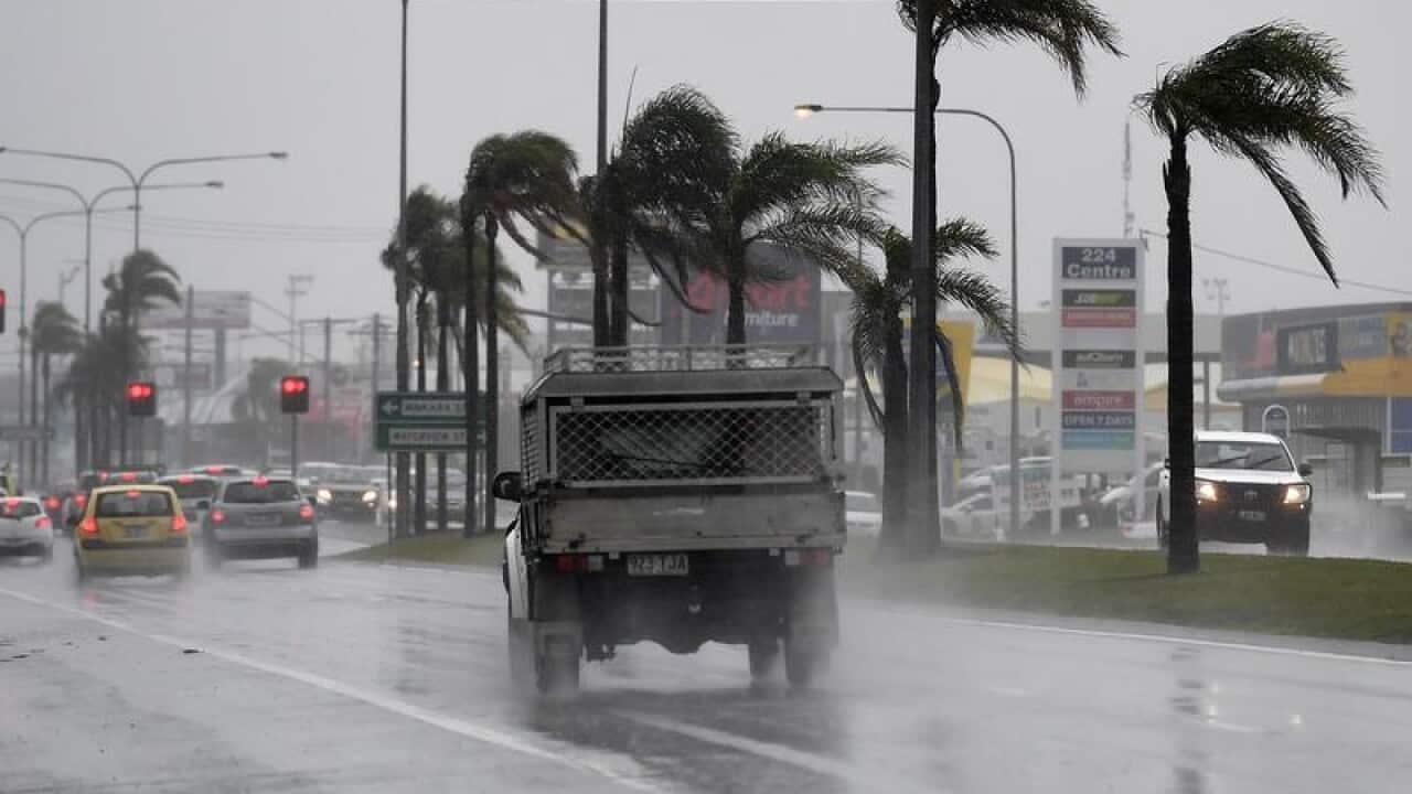 Drivers endure heavy rain and strong winds.