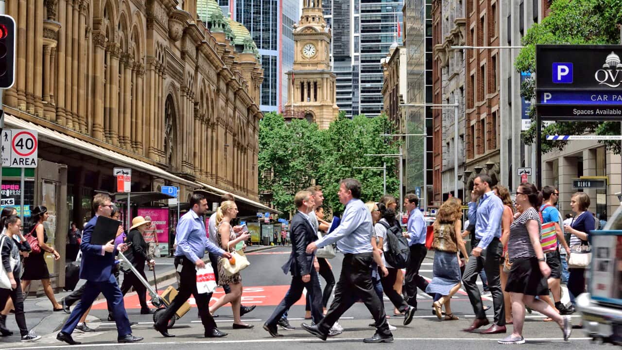 People crowd crossing street in central Sydney