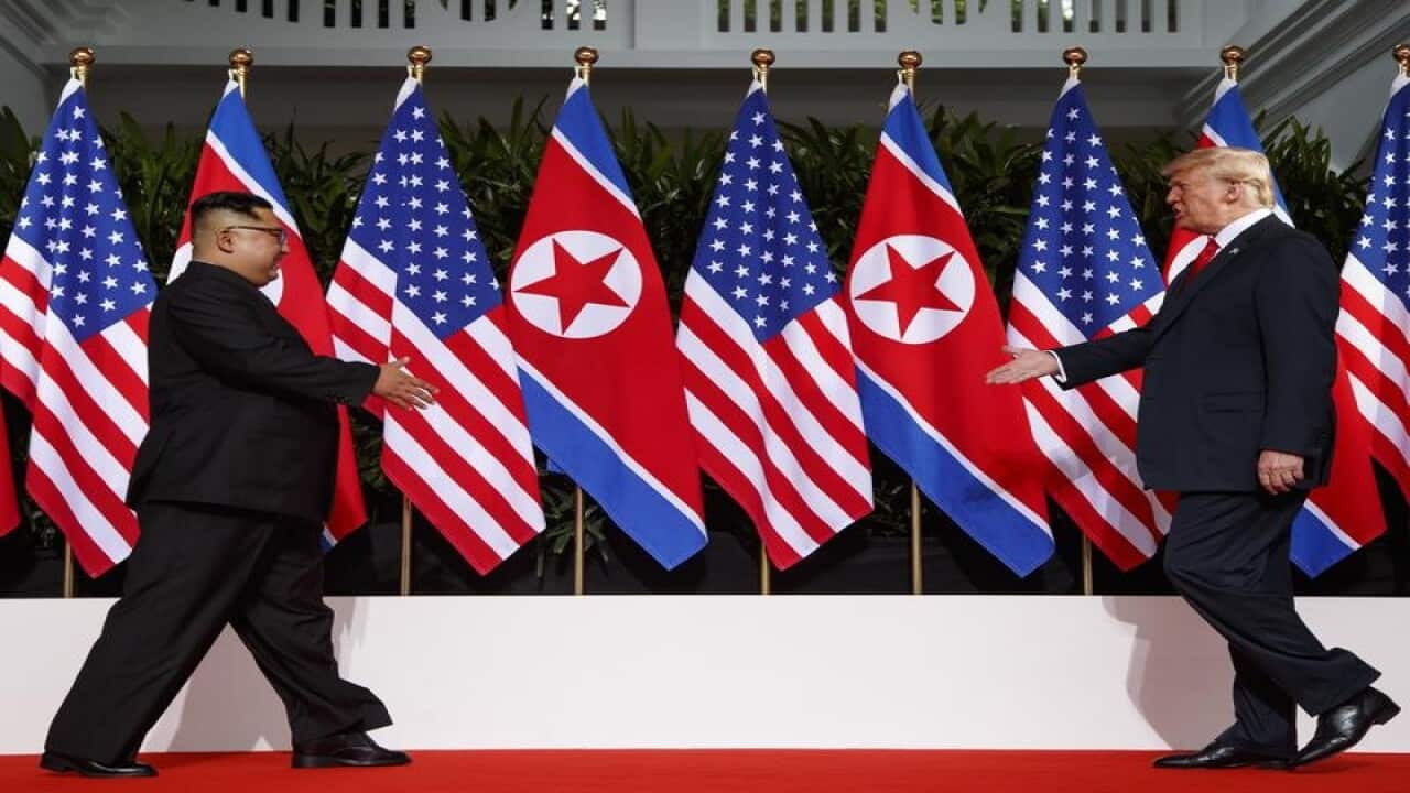 Kim Jong-un walks towards Donald Trump at their Singapore summit.