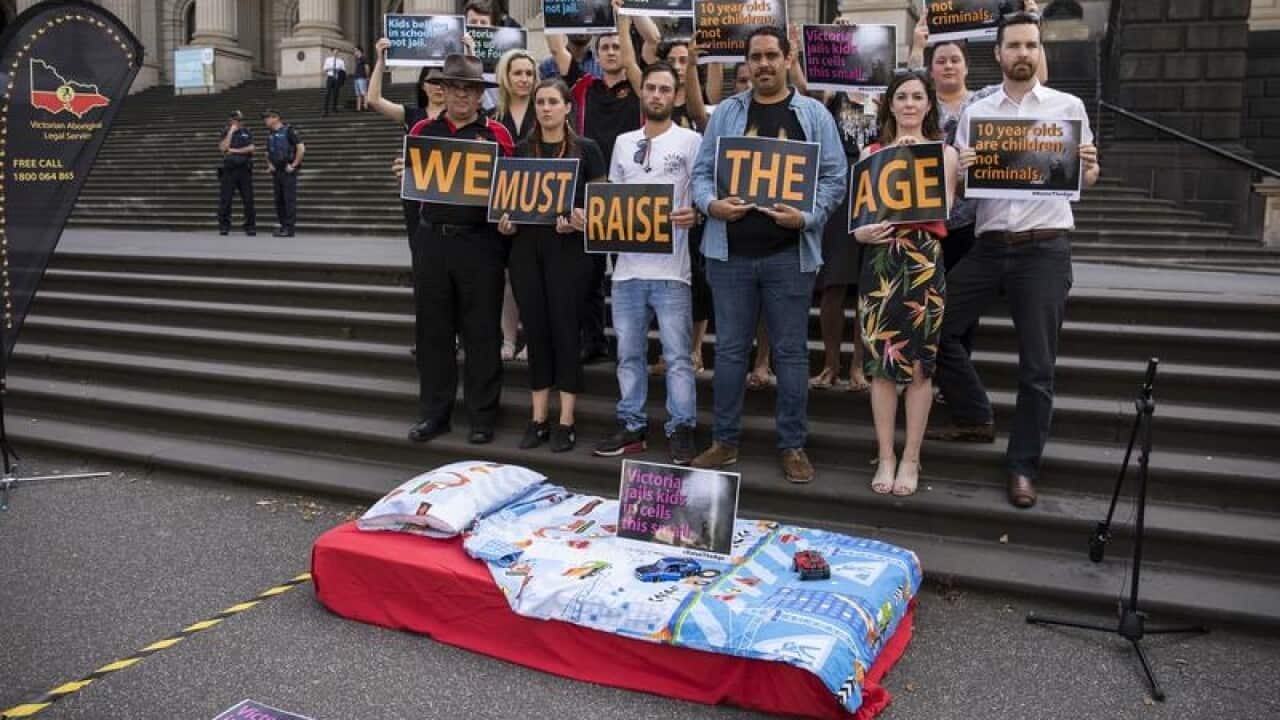 Protesters with a replica child's prison cell in Melbourne