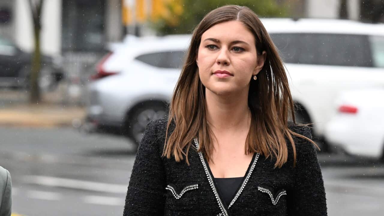 A woman wearing a black blazer
