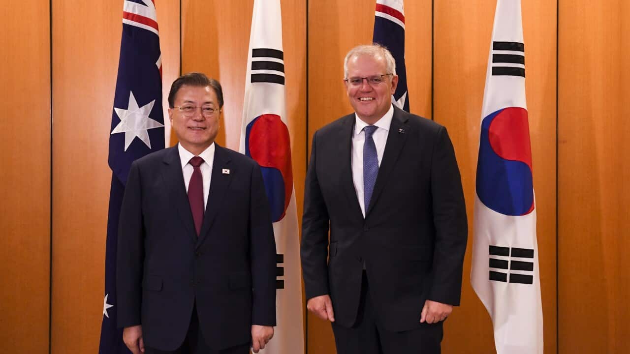 Australian Prime Minister Scott Morrison and South Korean President Moon Jae-in pose for photographs at Parliament House, Canberra, Monday, December 13, 2021.