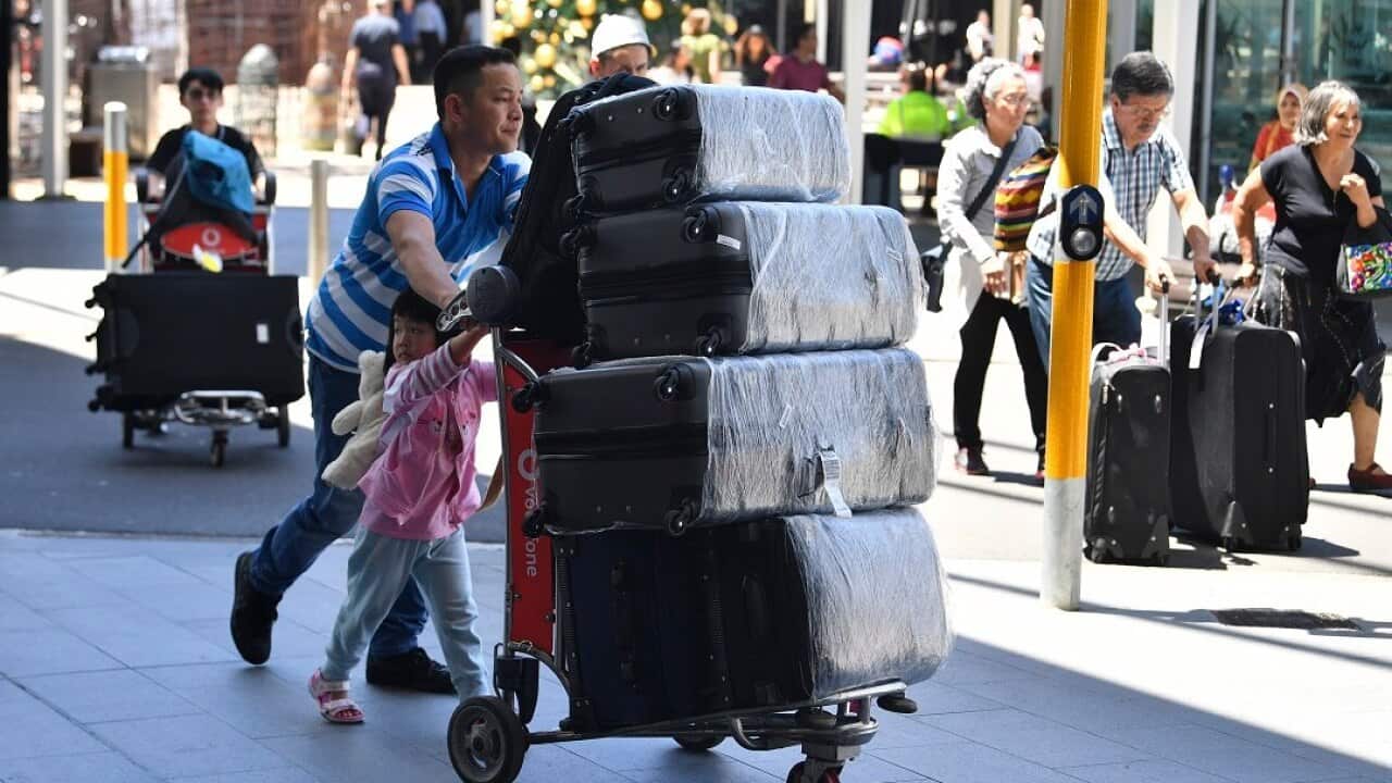 Travellers are seen at Overseas Arrivals and Departures (OAD) at Sydney's International Airport in Sydney, Monday, December 17, 2018. (AAP Image/Brendan Esposito) NO ARCHIVING