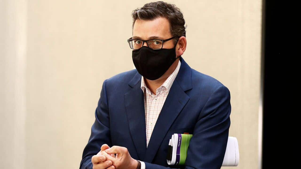 Premier Daniel Andrews leaves after speaking to the media during a press conference.