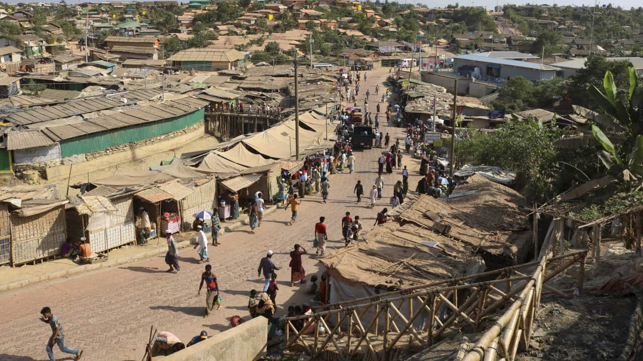 Rohingya refugees walk through one of the arterial roads at the Kutupalong refugee camp in Cox's Bazar, Bangladesh.