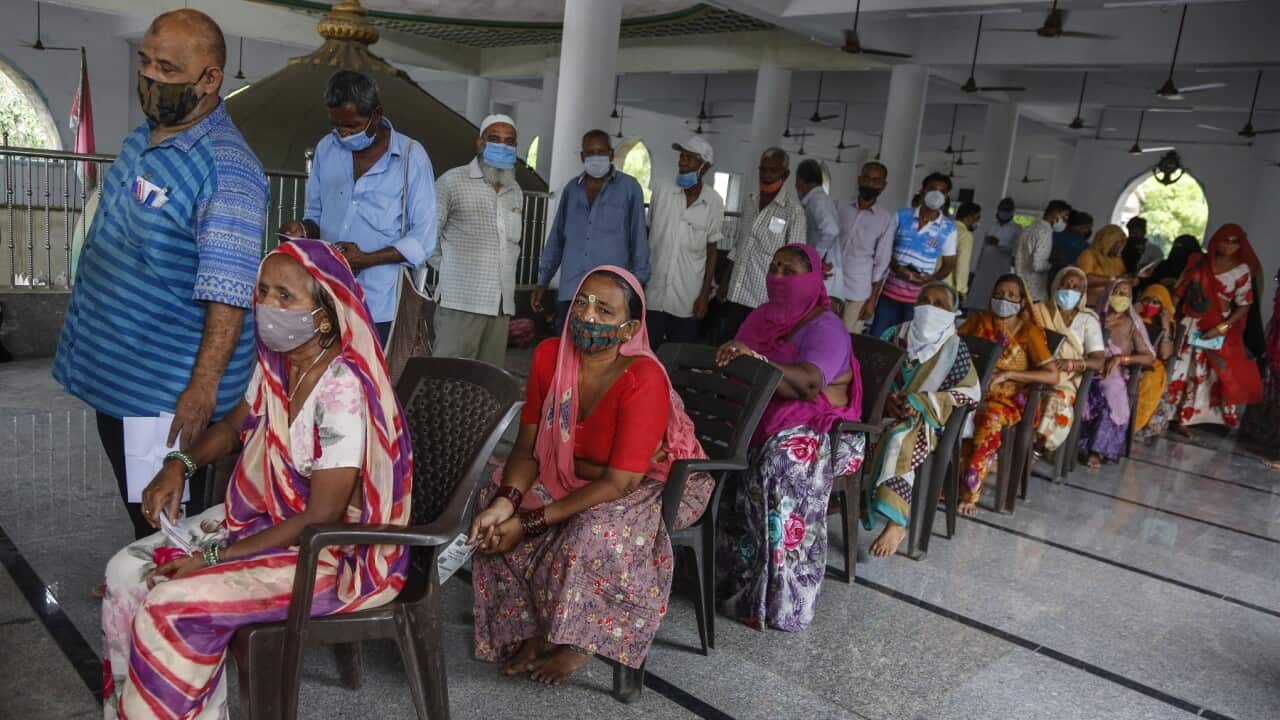 People line up to register for a COVID-19 vaccination at a mosque in Ahmedabad, India