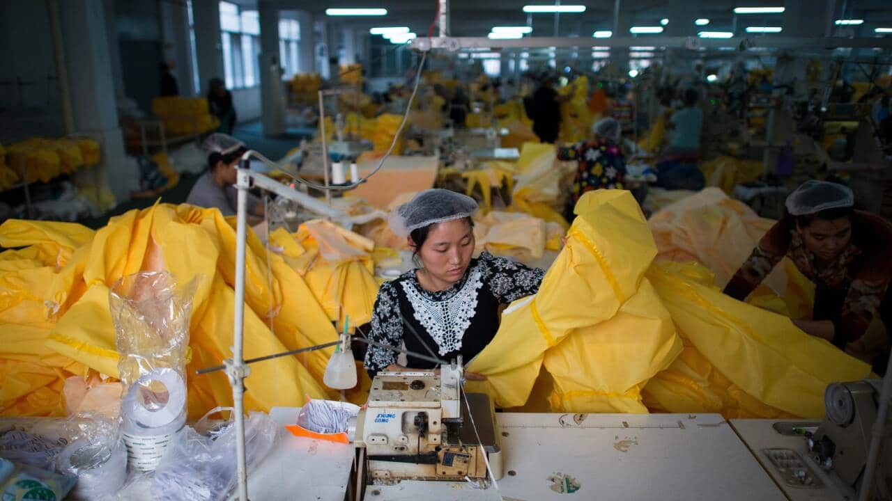 Woman makes an Ebola safety suit in Anqiu, China