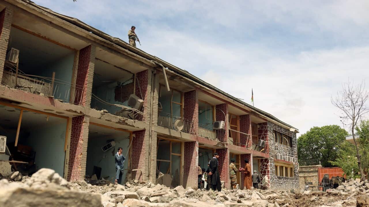 Afghan Army soldiers inspect the scene of a truck bomb blast that targeted the military courts in Gardez (AAP