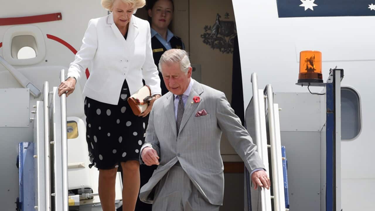 Britain's Prince Charles (C) and his wife as they land in Australia
