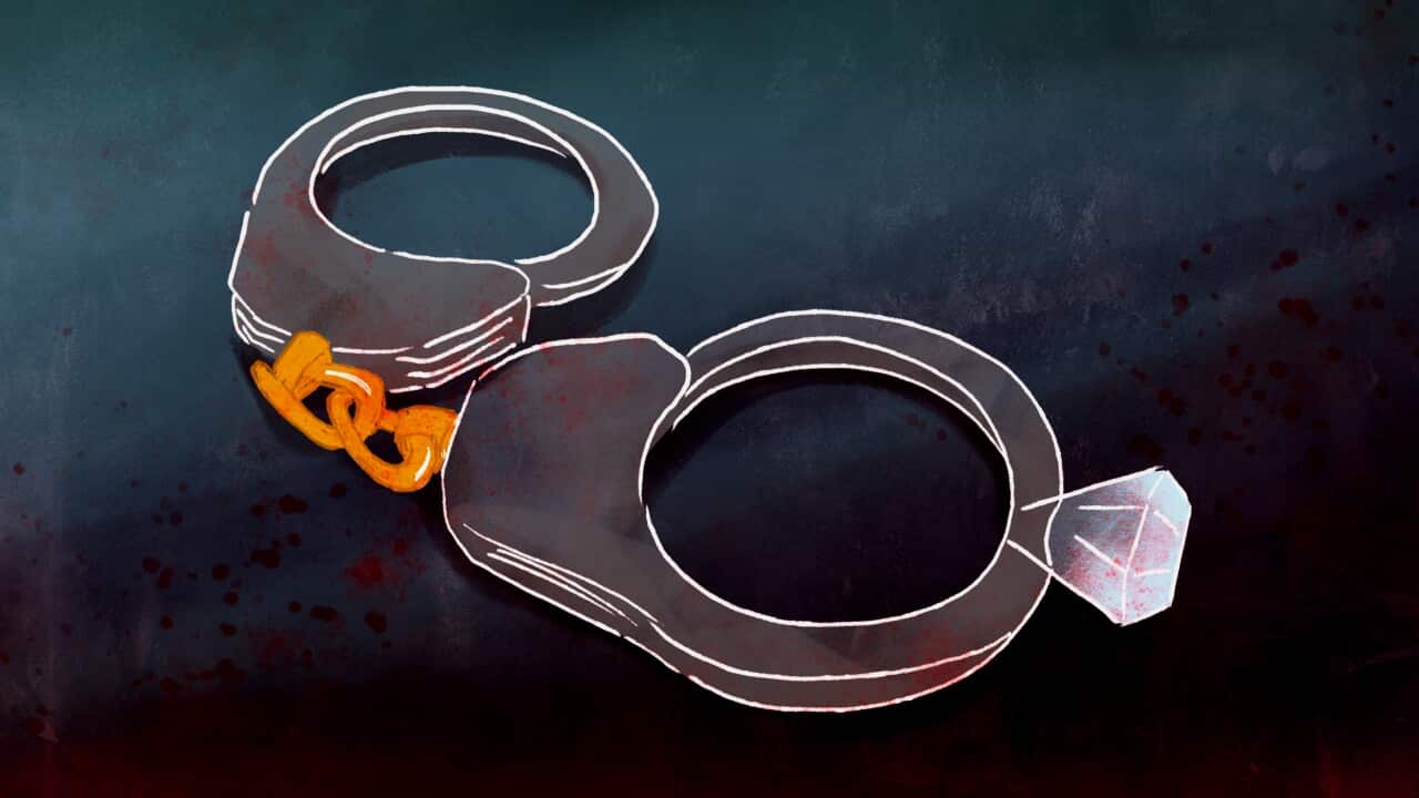 A digital illustration of a pair of handcuffs. They are connected by a gold chain. One has a diamond attached to it.