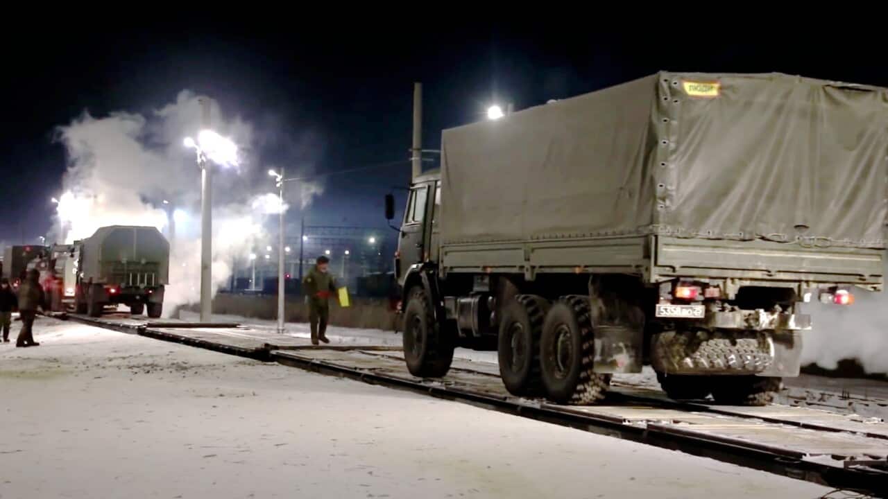 Russian military vehicle drives on a railway platform before transferring to attend a joint military drills in Belarus, in Russia, Monday, Jan. 24, 2022.